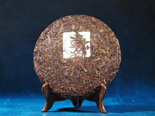 Front view of Spring Ming 2017 Aged Sheng Pu-erh Tea Cake – 400g (Lincang, Yunnan) with packaging removed, revealing the dense tea cake surface.