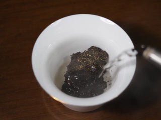 Dry pieces of YXT Jingyang Golden Flower Fu Tea Special Grade 300g in a porcelain gaiwan, ready for brewing.