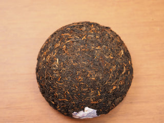 Top view of a single 2018 Dayi V93 ripe puerh tea tuo