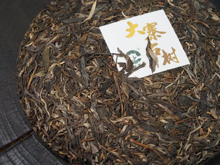 2020 Dazhai Ancient Tree Raw Pu-erh Tea Cake – Angled View Showing Cake Thickness and Compressed Form
