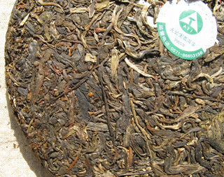Detailed texture of 20-year aged raw Pu-erh tea leaves from 2005 Mengku Spring Tips.