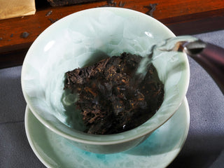 Steeping the 2018 Genshe Fu Brick tea in a celadon gaiwan, releasing the aged woody and mellow aroma.
