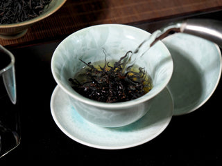 Steeping Wild Wilderness Dianhong Black Tea in a traditional gaiwan