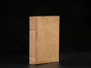 Inner packaging of the tea brick wrapped in traditional eco-friendly kraft paper.