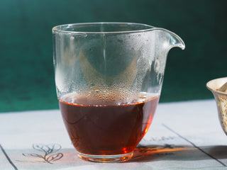 A clear, close-up view of the rich amber liquor from dry-stored fermented Puerh tea, showing its purity and thickness.
