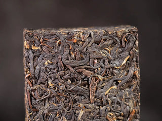 Close-up of high-quality compressed dark tea leaves in On Taoism Golden Flower Fu Brick.