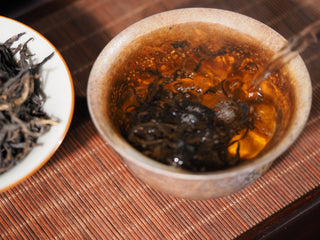 Pouring hot water over Ancient Tree Dianhong black tea leaves