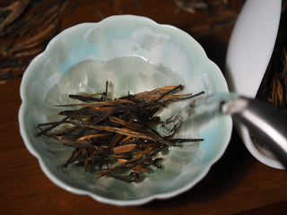 Pouring hot water over Imperial Dianhong Black Tea single buds