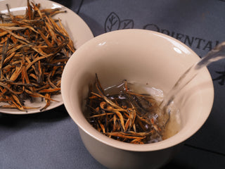 Pouring hot water over Golden Buds Classic Dianhong loose tea leaves