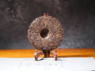 Back unwrapped view of the Sticky Rice Aroma Raw Pu-erh Cake 2013 200g revealing compression and leaf pattern