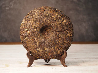 Back unwrapped view of Value Classic 2008 Tribute Sheng Pu-erh Tea Cake – 357g Menghai (2019 Pressed), displaying compressed tea surface