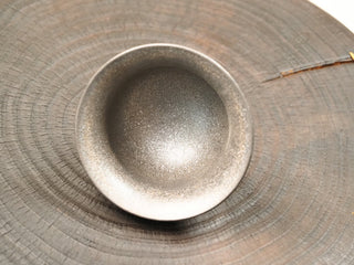 Interior of wood-fired stoneware gaiwan bowl from Dehua Fujian, dark speckled kiln-change glaze surface, 130ml capacity.