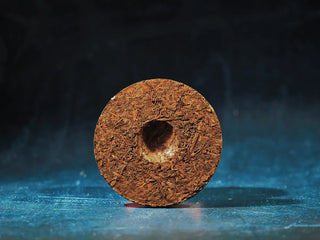 Unwrapped back view of the Yunnan Red Glow Ripe Pu-erh Tea Mini Cake – 100g, displaying the uniform texture and natural tea leaf patterns.