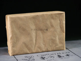Original kraft paper wrapping (發花原包裝) of the YXT Jingyang Fu Tea Ximanzi 2018 brick, preserving the Golden Flower bloom.