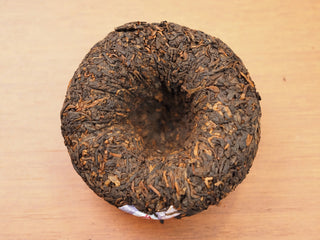 Bottom view of 2018 Dayi V93 ripe puerh tuo tea showing compressed shape