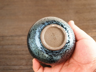 Unglazed base of a Jiang Jun Bei Jianzhan tea bowl with maker's mark, throwing rings, and trimmed foot ring typical of handcrafted Jianyang pottery.