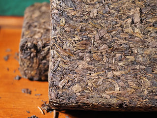 Another detailed close-up of Jingyang Golden Flower Fu Brick Tea corner, emphasizing the texture and density of hand-pressed tea leaves.