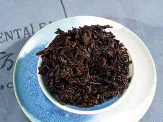 Wet tea leaves of aged Liubao tea after steeping, showing plump and fermented texture.