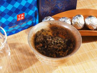 Wild ancient tree raw Puerh tea leaves unfurling and releasing rich flavor during steeping.