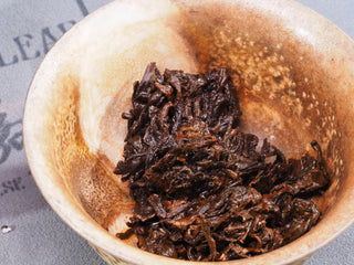 Wet, dark fermented Puerh tea leaves (Lao Cha Tou) in a gaiwan after multiple infusions, showing high pectin content.
