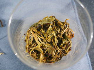 Infused wet leaves of Ailao Mountain yellow tea showing tender, high-quality Grade 1 buds.