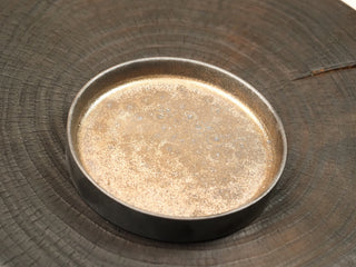 Interior of wood-fired stoneware tea tray from Dehua Fujian, light speckled glaze with natural kiln variations, 12cm diameter.
