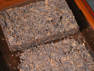 Broken chunks of Xiaguan Baoyan Ripe Puerh tea for brewing.