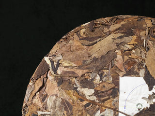 Detailed close-up of front portion of Yunnan High Mountain Wild Ancient Tree Shoumei White Tea Cake (2019) showing leaf texture