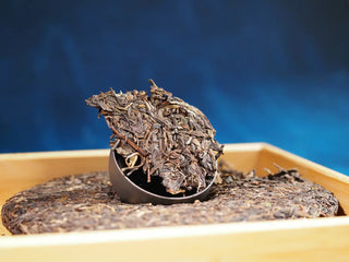 Close-up of a portion of Spring Ming 2017 Aged Sheng Pu-erh Tea Cake – 400g (Lincang, Yunnan), highlighting leaf color, texture, and quality.