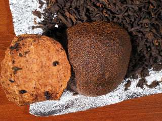 Macro shot showing the oily exterior and dark aged interior of Xinhui citrus peel (Chenpi).