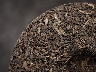 Close-up of the back surface of 2019 Lincang Ancient Arbor Sheng Pu-erh Tea Cake highlighting dense leaf structure
