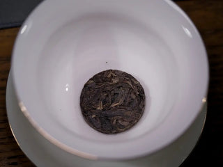 Mengku TeaSoul Sheng Pu-erh Coin Tea placed in a traditional gaiwan for brewing