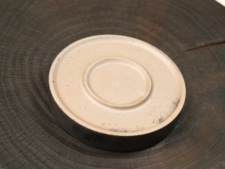 Bottom of wood-fired stoneware tea tray from Dehua Fujian, unglazed foot ring with visible raw clay and impressed marking.