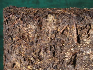 Close-up texture of the YXT Jingyang Fu Tea Ximanzi 2018 brick, showing the detail of this premium Shaanxi Dark Tea.