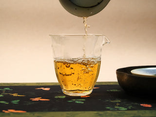 Golden amber tea liquor poured from gaiwan into fairness pitcher, bright clear color of 2018 indoor-withered White Peony.