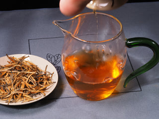 Golden amber liquor of brewed Golden Buds Classic Dianhong Black Tea