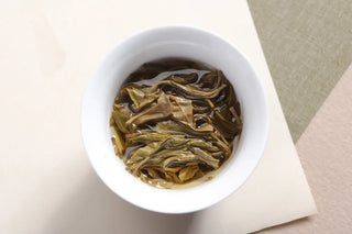 Wet leaves (tea bottom) of the Ancient Tree Raw Pu-erh Tea, showing the quality, whole leaves after brewing.