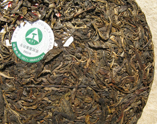 Close-up of the anti-counterfeit and verification label on the 2005 Mengku tea cake.