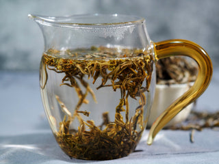 Wet tea leaves of high mountain yellow tea showing vibrant yellowish-green color.