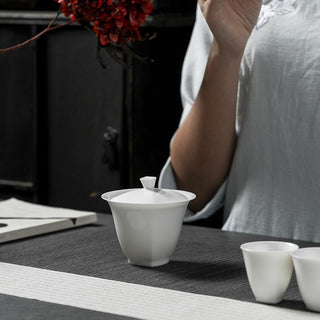 Lifestyle shot of white porcelain gaiwan in a serene tea ceremony setting