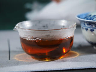 Side view of the clear, amber-colored aged Hei Cha liquor, reflecting its smooth and mellow maturation since 2015.
