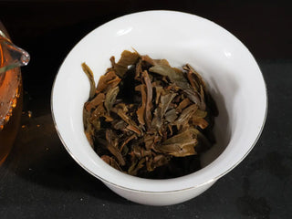 High-quality expanded wet leaves of Yiwu Big Tree Raw Puerh after brewing.