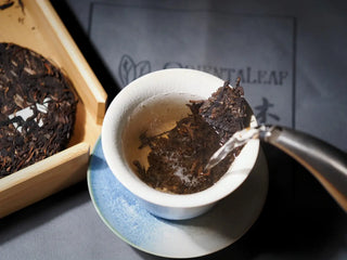Yiwu Raw Pu-erh Cake – 2013 Spring Tea, Hand-Pressed 2023, Sweet & Layered (100g) brewing in a gaiwan with hot water poured over leaves, showing tea infusion process