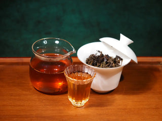 Complete brewing display of YXT Jingyang Golden Flower Fu Tea Special Grade 300g: showcasing the dark liquor, wet leaves, and gaiwan.