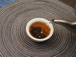 Hot water being added to 2018 Dayi V93 ripe puerh tea leaves