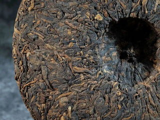 Close-up of the back surface of Bulang Mountain Ancient Tree Ripe Pu-erh tea cake, showcasing detailed tea leaf texture and uniformity