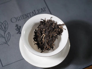 Small piece of 2018 Dazhai Ancient Tree Raw Pu-erh Tea Cake in gaiwan, ready for brewing