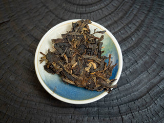 High-angle shot of 2006 premium aged raw Puerh loose tea leaves ready for brewing.