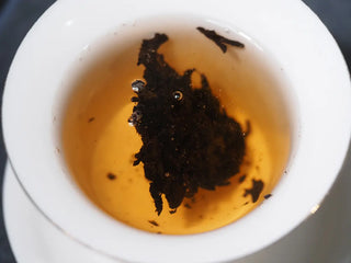 The initial infusion of Xiaguan Baoyan ripe Puerh showing clarity and color.