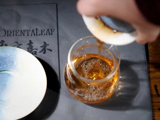 Yiwu Raw Pu-erh Cake – 2013 Spring Tea, Hand-Pressed 2023, Sweet & Layered (100g) tea being poured from gaiwan into a gongdaobei, showing clear amber tea liquor